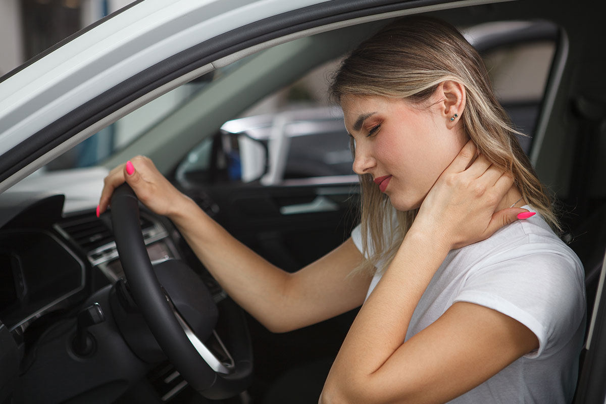 woman holding neck before car accident injury treatment in Fort Worth.