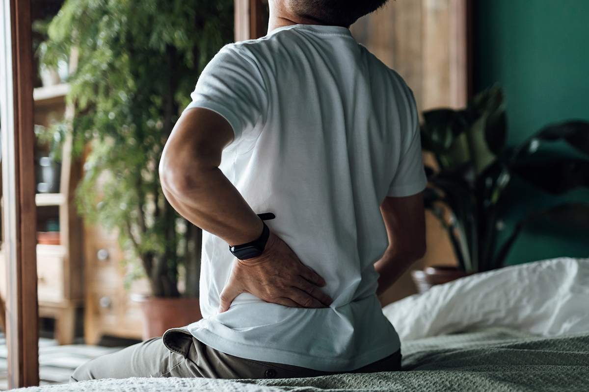 man in bed before back pain treatment in Irving and Fort Worth